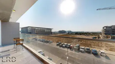 a balcony with a row of chairs and a building at Chic & Cozy 1BR in Centurion Onyx in Dubai
