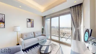 a living room with a couch and a large window at Chic & Cozy 1BR in Centurion Onyx in Dubai
