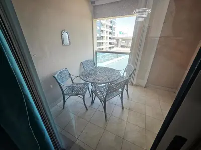 a table and chairs in a room with a window at Budget Spacious Room Heart of marina in Dubai