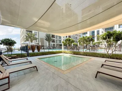 a swimming pool in the middle of a building at Lux Creek Home with Burj View steps from the Lagoon in Dubai
