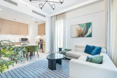 a living room with a couch and a table at Lux Creek Home with Burj View steps from the Lagoon in Dubai