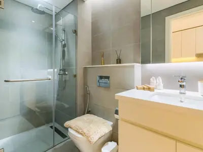a bathroom with a shower and a toilet and a sink at TRPS - Ahad Residences, Business Bay - Full Burj Khalifa View - Modern Furnished Studio in Dubai