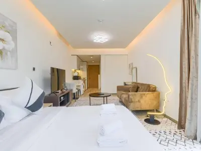 a hotel room with a bed and a couch at TRPS - Ahad Residences, Business Bay - Full Burj Khalifa View - Modern Furnished Studio in Dubai