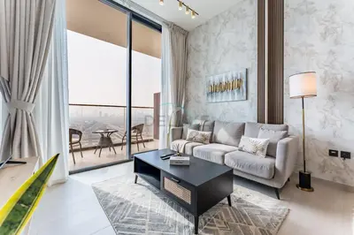 a living room with a couch and a table at Sky Level 1BR with Lake View and City Glimpse, Close Proximity to Community Park, Binghatti Onyx, Jumeirah Village Circle by Deluxe Holiday Homes in Dubai