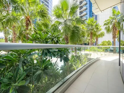 a balcony with palm trees in a building at Elegant 2 Bedroom Apartment with Pool Views at Business Bay 211DPA-2 in Dubai