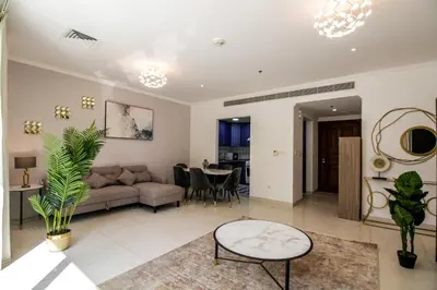 a living room with a couch and a table at Spacious 1BR with Balcony in JLT Cluster E in Dubai