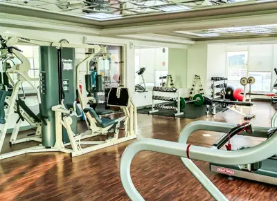 a gym with several treadmills and machines at Spacious 1BR with Balcony in JLT Cluster E in Dubai