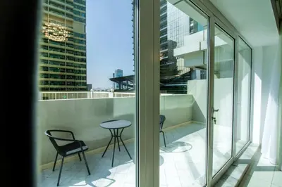 a balcony with chairs and a table on a building at Spacious 1BR with Balcony in JLT Cluster E in Dubai