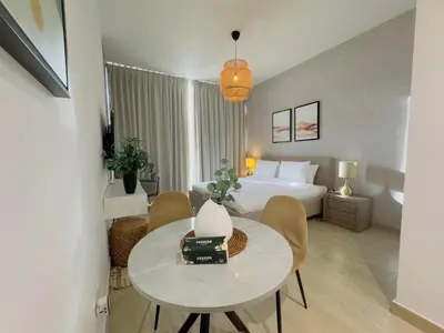 a hotel room with a bed and a table and chairs at Sky-High Studio Marina Skyline View Bloom Tower in Dubai