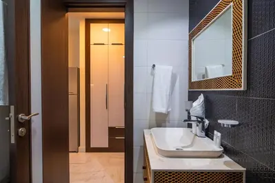 a bathroom with a sink and a mirror at Stylish Studio Bayz Danube Burj Khalifa View Pool in Dubai