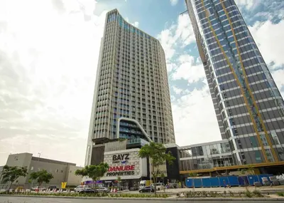 two tall buildings with a sign in front of them at Stylish Studio Bayz Danube Burj Khalifa View Pool in Dubai