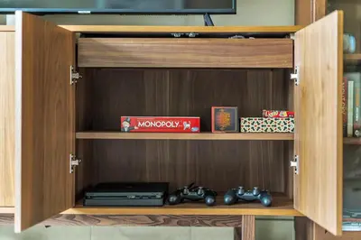 a wooden entertainment center with two toy trains in it at DAYF-BVE Large 1BR in Downtown Steps to Dubai Mall in Dubai