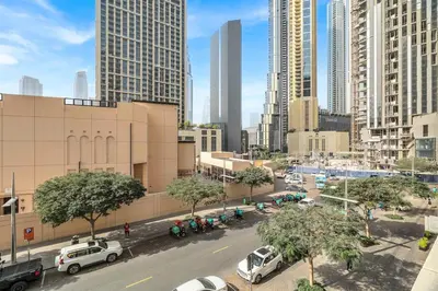a city with cars parked on a street with tall buildings at DAYF-BVE Large 1BR in Downtown Steps to Dubai Mall in Dubai