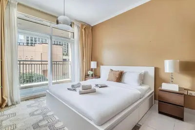 a bedroom with a large white bed and a window at DAYF-BVE Large 1BR in Downtown Steps to Dubai Mall in Dubai