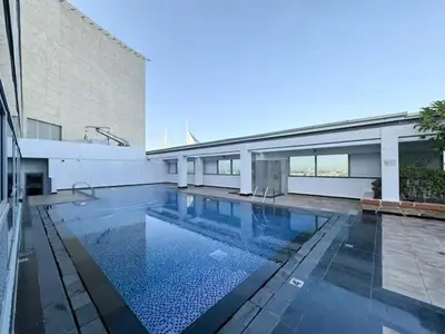 a swimming pool in front of a building at DAYF-SKG04 Modern Spacious 1 Bed Full DIFC Views in Dubai