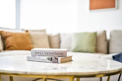 two books on a coffee table in a living room at DAYF-SKG04 Modern Spacious 1 Bed Full DIFC Views in Dubai