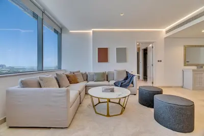 a living room with a couch and a table at DAYF-SKG04 Modern Spacious 1 Bed Full DIFC Views in Dubai
