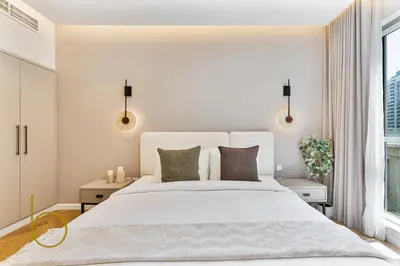a bedroom with a white bed and a window at Bookable - 2 Bedroom Boulevard Central in Dubai