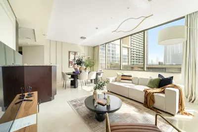 a living room with a couch and a table at Silkhaus Premium 2BDR Stay in Sky Gardens DIFC in Dubai