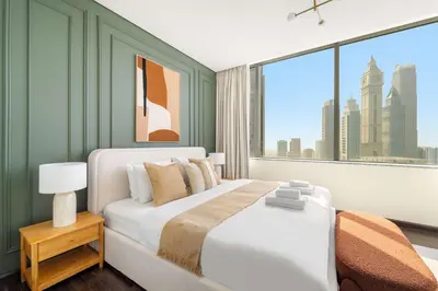 a bedroom with a large bed and a large window at Silkhaus Premium 2BDR Stay in Sky Gardens DIFC in Dubai