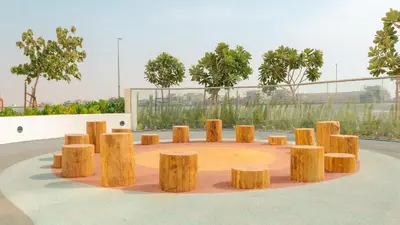 a group of wooden stools in a circle at KeyRock Golf Gate - Relax and Unwind with Pool and Sauna in Dubai