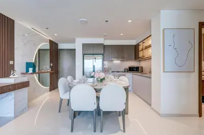 a kitchen and dining room with a table and chairs at Beachfront Bliss 2Bedroom in Grand Bleu in Dubai