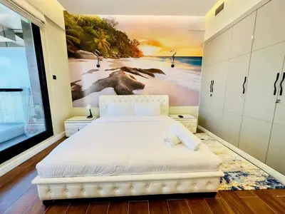 a bedroom with a bed with a painting on the wall at Upgraded High Rise 2 Br Full Marina Canal View in Dubai