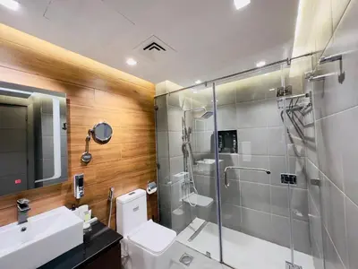 a bathroom with a shower and a toilet and a sink at Upgraded High Rise 2 Br Full Marina Canal View in Dubai