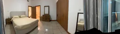 a bedroom with a bed and a mirror at Stylish 1 bedroom apartment with full kitchen in Dubai
