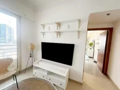 a living room with a flat screen tv on a wall at Luxury 1 BHK in Dubai Marina By dPie Man 1011 in Dubai