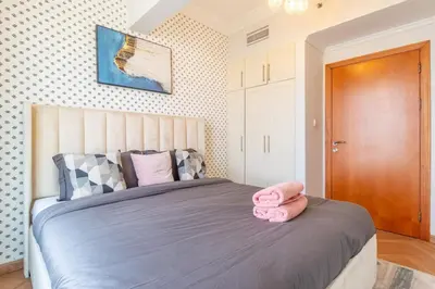 a bedroom with a bed with pink towels on it at Luxury 1 BHK in Dubai Marina By dPie Man 1710 in Dubai