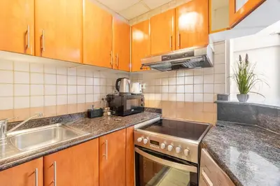 a kitchen with a sink and a stove at Luxury 1 BHK in Dubai Marina By dPie Man 1710 in Dubai