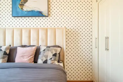 a bedroom with a bed and a wall with polka dots at Luxury 1 BHK in Dubai Marina By dPie Man 1710 in Dubai