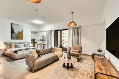 a living room with a couch and a bed at Modern & Spacious Studio in JBR in Dubai