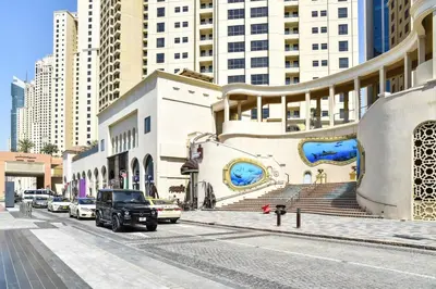 a street with cars parked in front of a building at Modern & Spacious Studio in JBR in Dubai