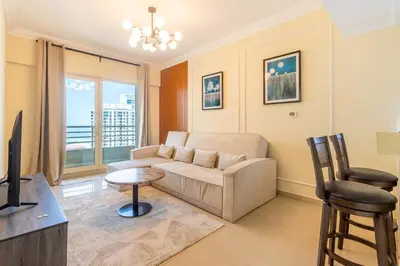 a living room with a couch and a table at Luxury 3BR in Dubai Marina Man 2203 in Dubai