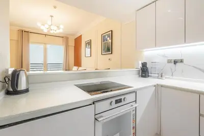 a kitchen with white cabinets and a sink at Luxury 3BR in Dubai Marina Man 2203 in Dubai