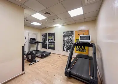 a gym with two treadmills and two exercise bikes at Luxury 3BR in Dubai Marina Man 2203 in Dubai