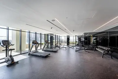 a gym with treadmills and machines in a building at Elegant 1B Missoni-Near Burj & Dubai Mall in Dubai