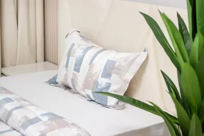 a pillow sitting on a couch with a plant at Luxury 2BR in Dubai Marina Man 405 in Dubai