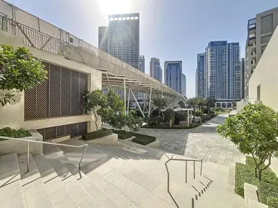 a view of a building in a city with tall buildings at Lotus Creek Beach - Opulent One Bed with Pool View in Dubai