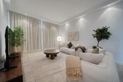 a living room with two couches and a tv at Cozy and Spacious 2Bedroom with Marina Bay view in Dubai
