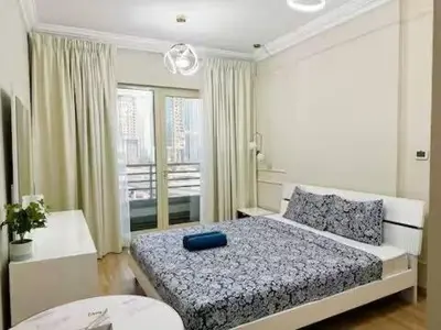 a bedroom with a bed with a blue pillow on it at Luxury 2BR in Dubai Marina Man 912 in Dubai