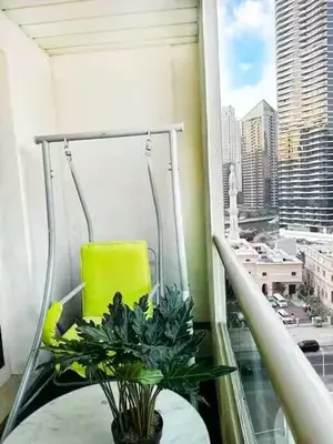 a balcony with a table with a plant on it at Luxury 2BR in Dubai Marina Man 912 in Dubai