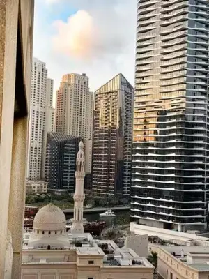 a view of a city with a statue and buildings at Luxury 2BR in Dubai Marina Man 912 in Dubai