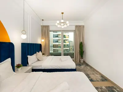 a bedroom with two beds and a chandelier at Luxury 3BHK w Floating Bed in Dubai Marina Man 2805 in Dubai
