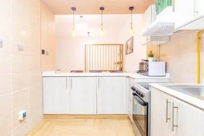 a large kitchen with white cabinets and a sink at Luxury 2BHK in Dubai Marina By dPie MP 1514 in Dubai