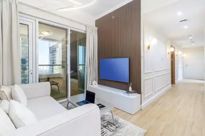 a living room with a white couch and a flat screen tv at Luxury 2BHK in Dubai Marina w Views Sulafa 1101 in Dubai