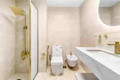 a white bathroom with a toilet and a sink at Luxury 2BHK in Dubai Marina w Views Sulafa 1101 in Dubai