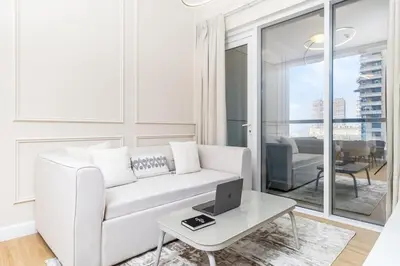 a white living room with a white couch and a table at Luxury 2BHK in Dubai Marina w Views Sulafa 1101 in Dubai